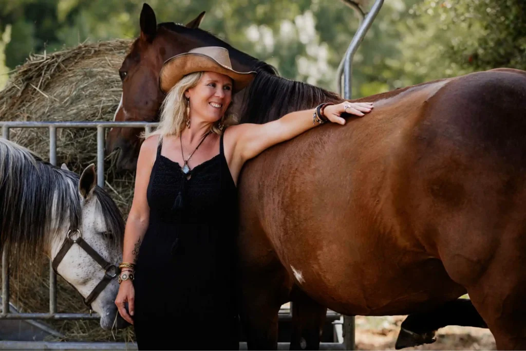 Cypriane Guyot caressant son cheval sur le dos